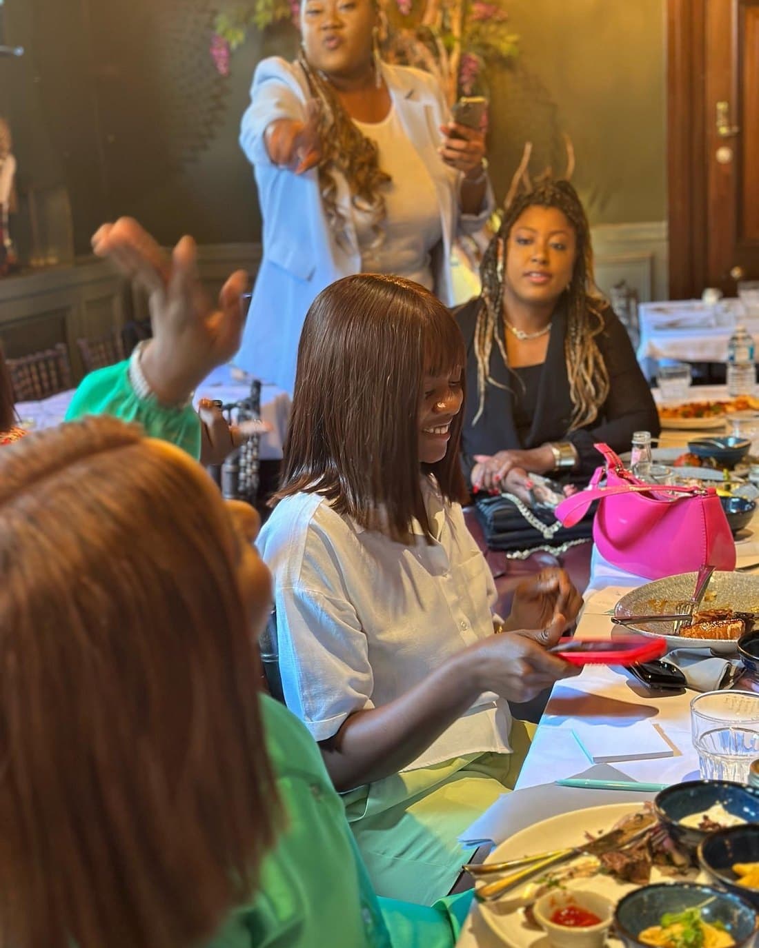 Members of the Enterprise Hub working together around a table of handmade goods