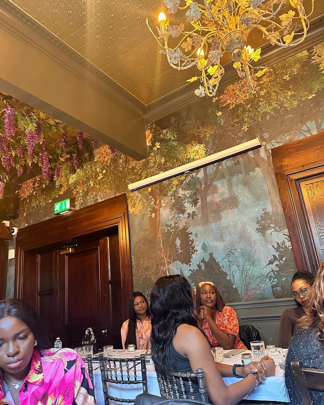 A leadership session under the chandeliers of a function room
